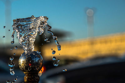 Close-up of water splashing against sky