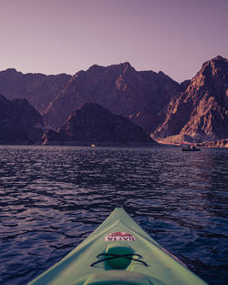 Scenic view of sea and mountains against clear sky