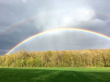 Scenic view of rainbow over field
