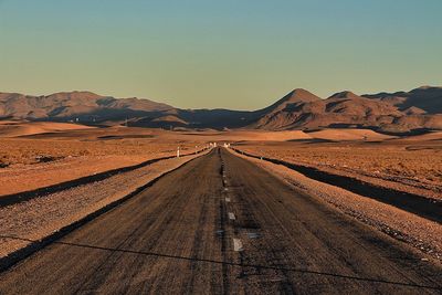 Road in desert against clear sky