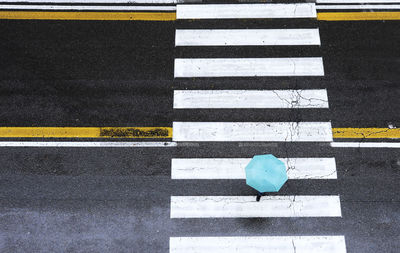 High angle view of crossing sign on road