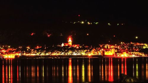 Illuminated firework display at night