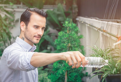 Portrait of young man in greenhouse