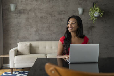 Young black woman working at home with laptop on desk. home office concept. gray notebook. 