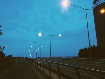 Empty road against sky at dusk