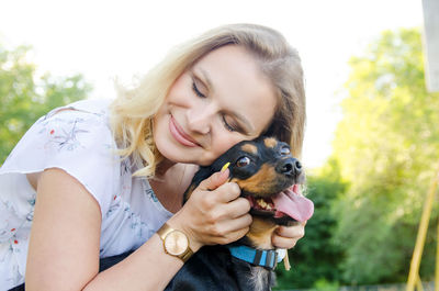 Portrait of a smiling woman with dog