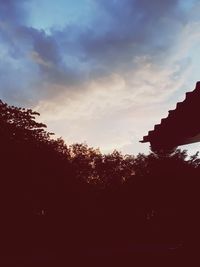 Low angle view of silhouette trees against sky at sunset