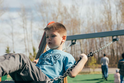 Portrait of young man standing on railing