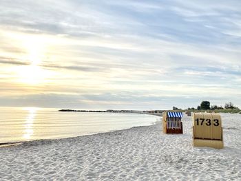 Hooded chairs on beach against sky during sunset ostsee kalifornien 