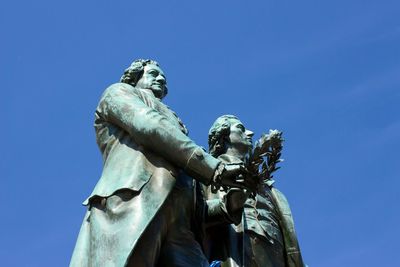 Low angle view of statue against clear blue sky