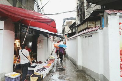 Man hanging amidst buildings