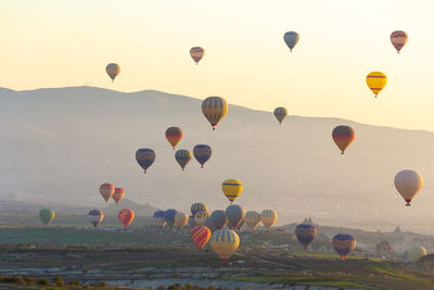 Hot air balloons flying against sky