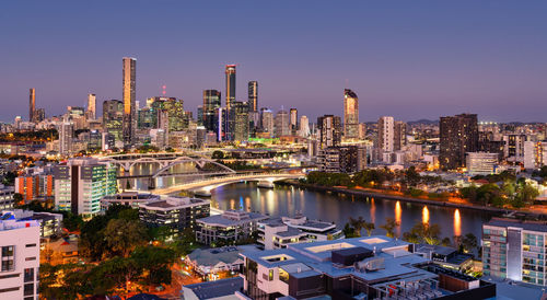 Aerial view of buildings in city against sky