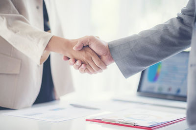 Close-up of business people shaking hands