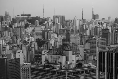 Aerial view of buildings in city against sky