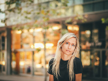 Portrait of woman in illuminated city