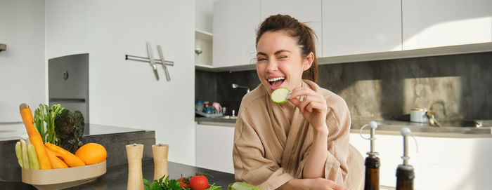 Portrait of young woman eating food