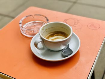  cappuccino on orange table 