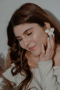 Close-up of beautiful smiling young woman at home