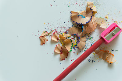 High angle view of pencils on table against white background