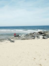 People on beach against sky