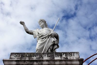 Low angle view of statue against sky