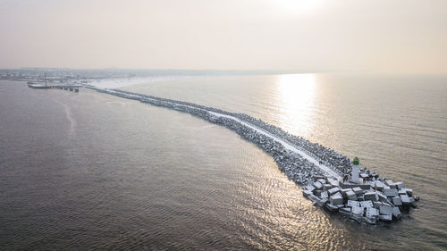 Aerial view of lighthouse in sea against sky