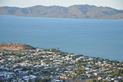 High angle view of townscape by sea against sky