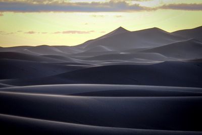 Scenic view of desert against sky during sunset