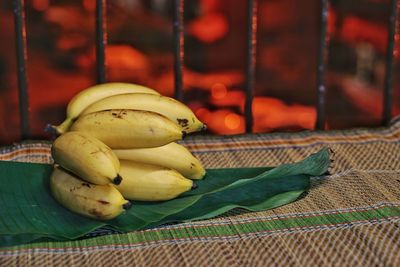 High angle view of bananas with leaves on table