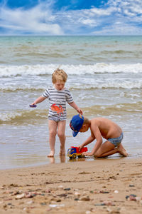 Full length of boy playing at beach