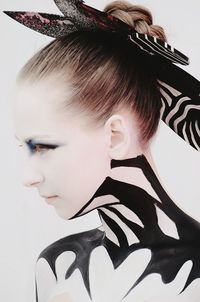 Close-up portrait of young woman over white background
