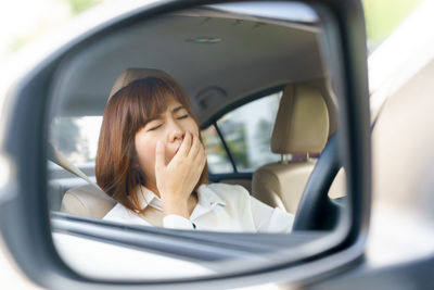 Portrait of smiling woman in car