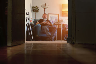 Rear view of woman looking through window