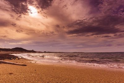 Scenic view of beach against sky during sunset