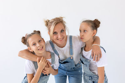 Portrait of happy friends against white background