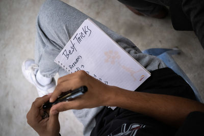 Midsection of man using mobile phone