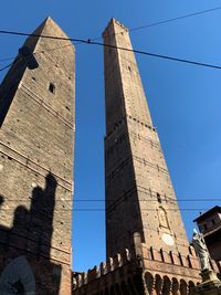 Low angle view of historic building against clear blue sky