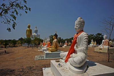 Statue against temple against clear sky