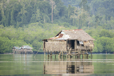 Gazebo in lake against trees