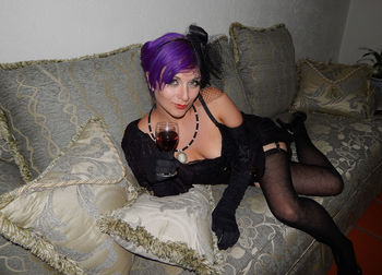 Portrait of young woman sitting on bench