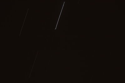 Vapor trails in sky at night