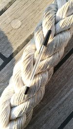 High angle view of rope tied on wood