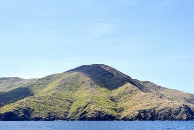 Scenic view of mountains against blue sky