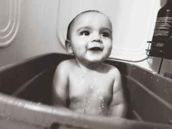 Portrait of cute baby boy bathing in bathroom