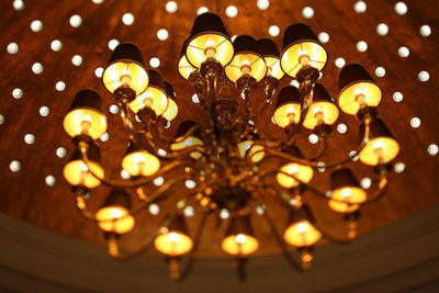 Low angle view of illuminated light bulbs