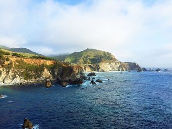 Scenic view of mountains against cloudy sky