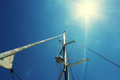 Low angle view of windmill against blue sky