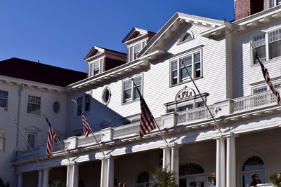 Low angle view of buildings against clear blue sky