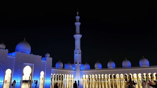 Illuminated building against sky at night